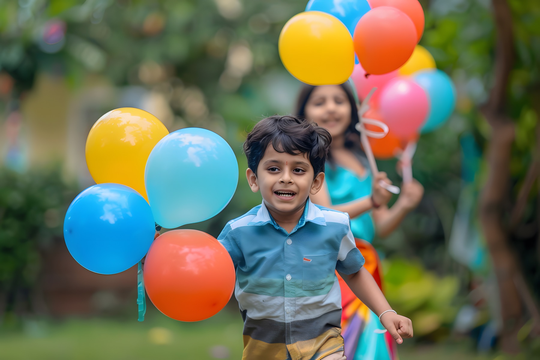 A boy runs through a park with a bunch of colourful balloons